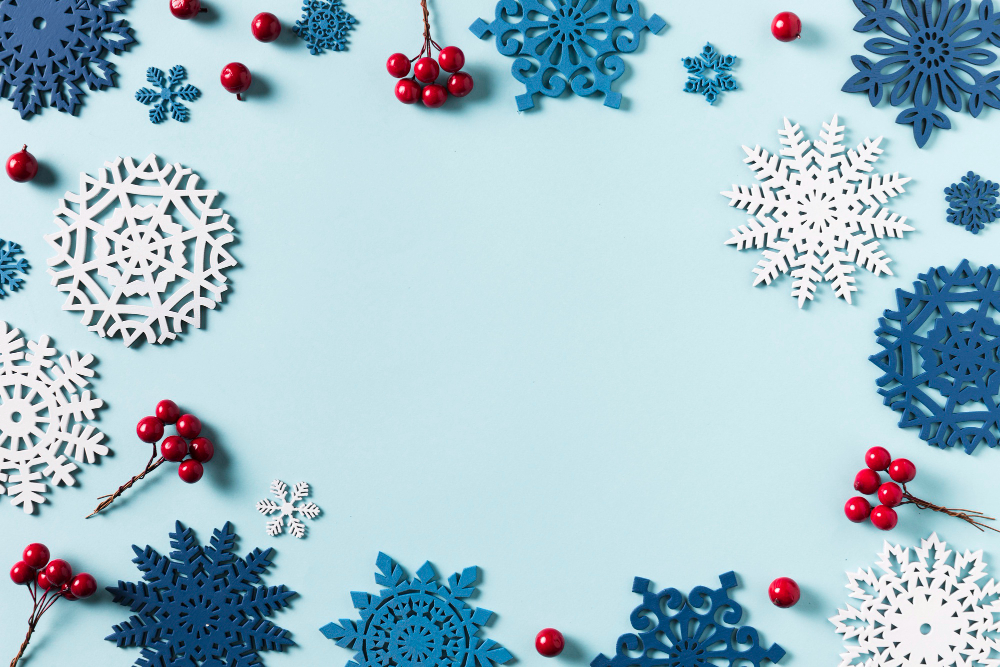 Niebieskie tło, Śnieżynki i jarzębina otaczające krawędzie obrazki, klimat Bożonarodzeniowy